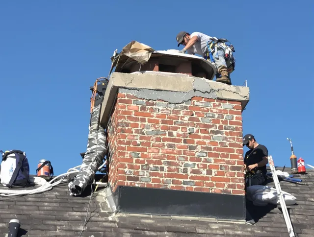 Barrington Chimney Sweep installing a custom chimney crown in Barrington, RI