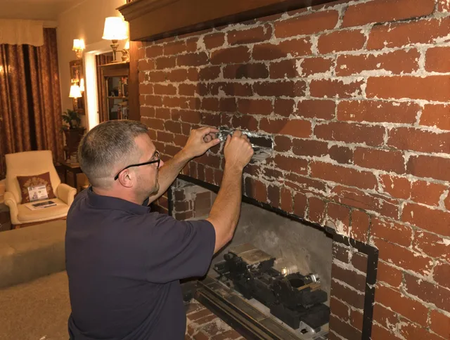 Barrington Chimney Sweep expert fixing a fireplace in Barrington, RI